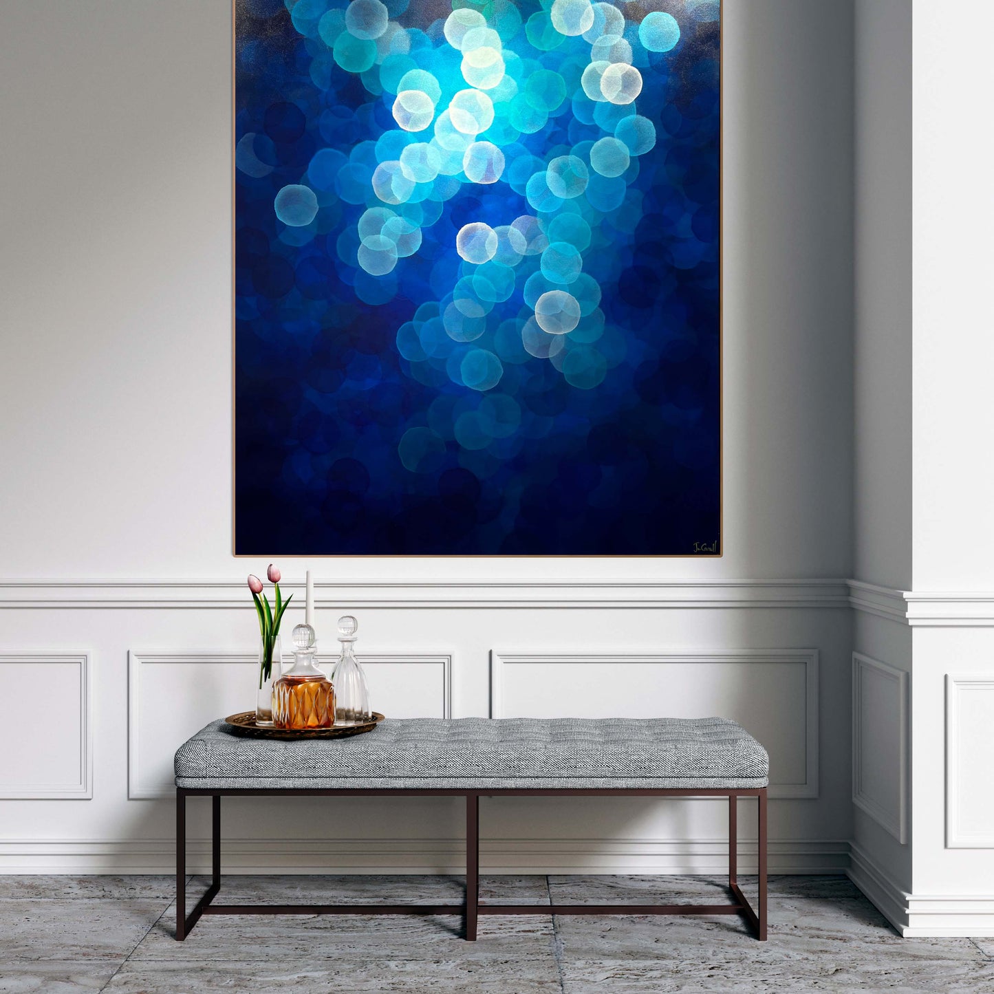 Aqueous Ascending is a large original artwork with calming blue tones and floating orbs. Art on wall above ottoman. Welcoming hallway to home.