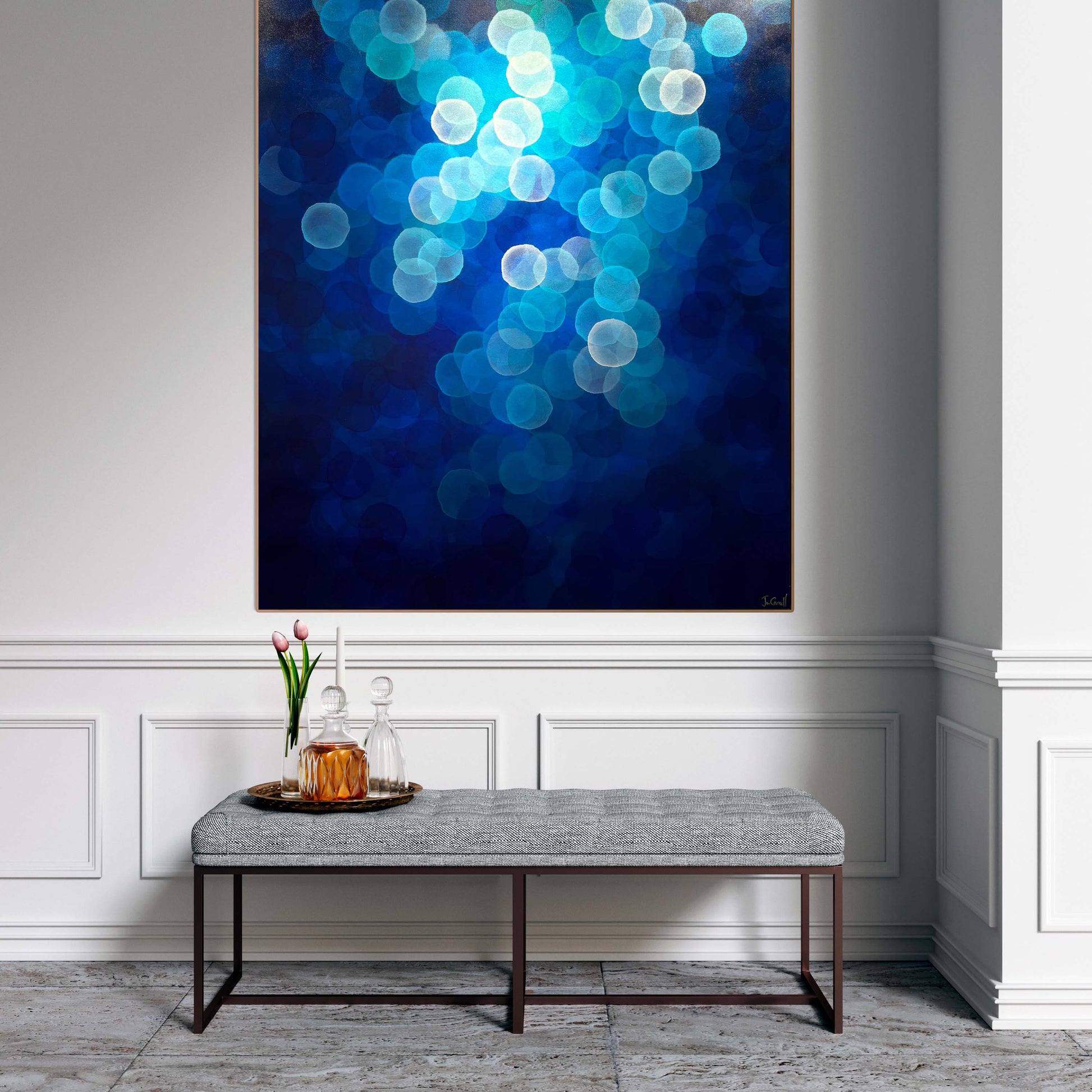 Aqueous Ascending is a large original artwork with calming blue tones and floating orbs. Art on wall above ottoman. Welcoming hallway to home.