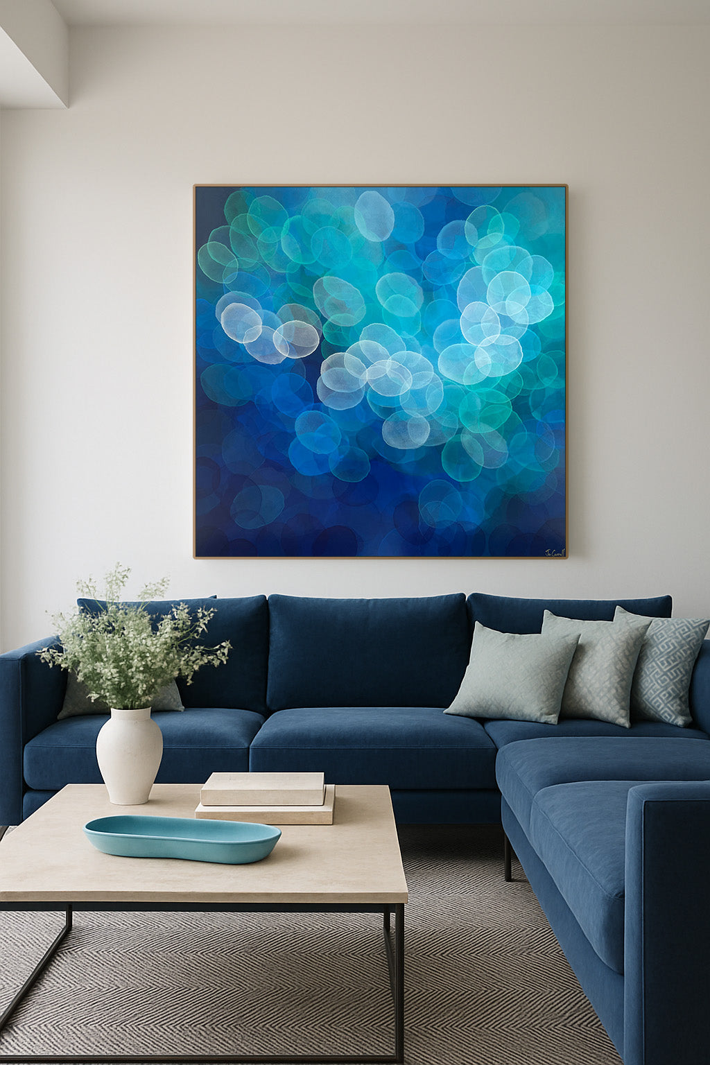 Modern living room with a blue sectional sofa, abstract artwork, and decorative items.