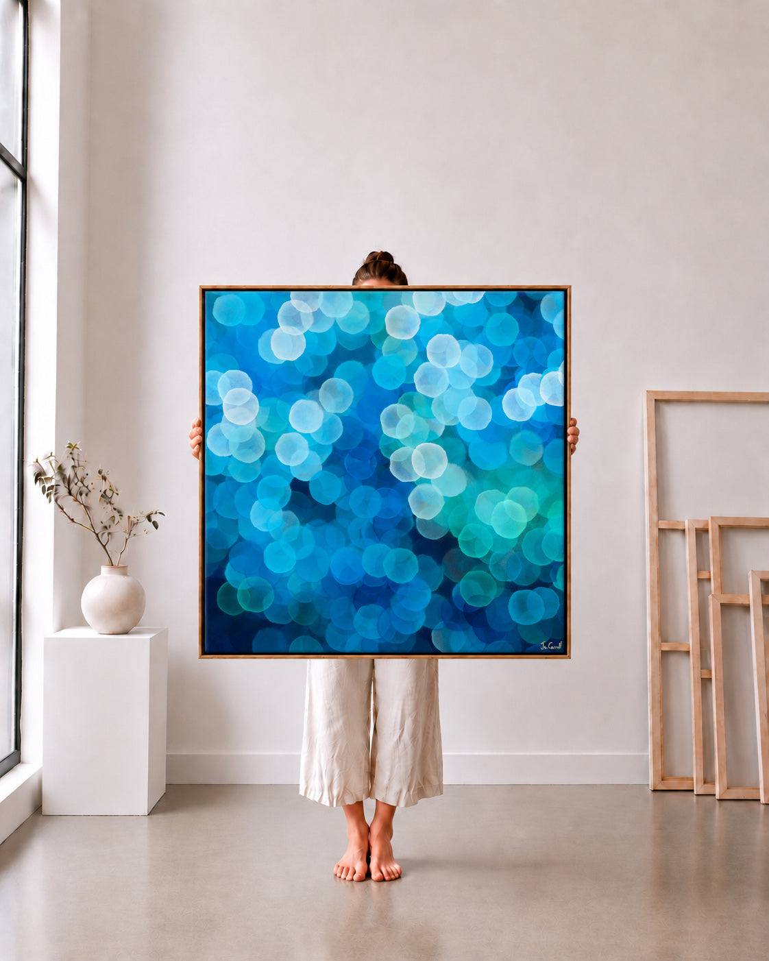 Orb Series 1 limited edition metallic canvas print, blue and teal orbs, 105x105cm oak frame held in a white studio