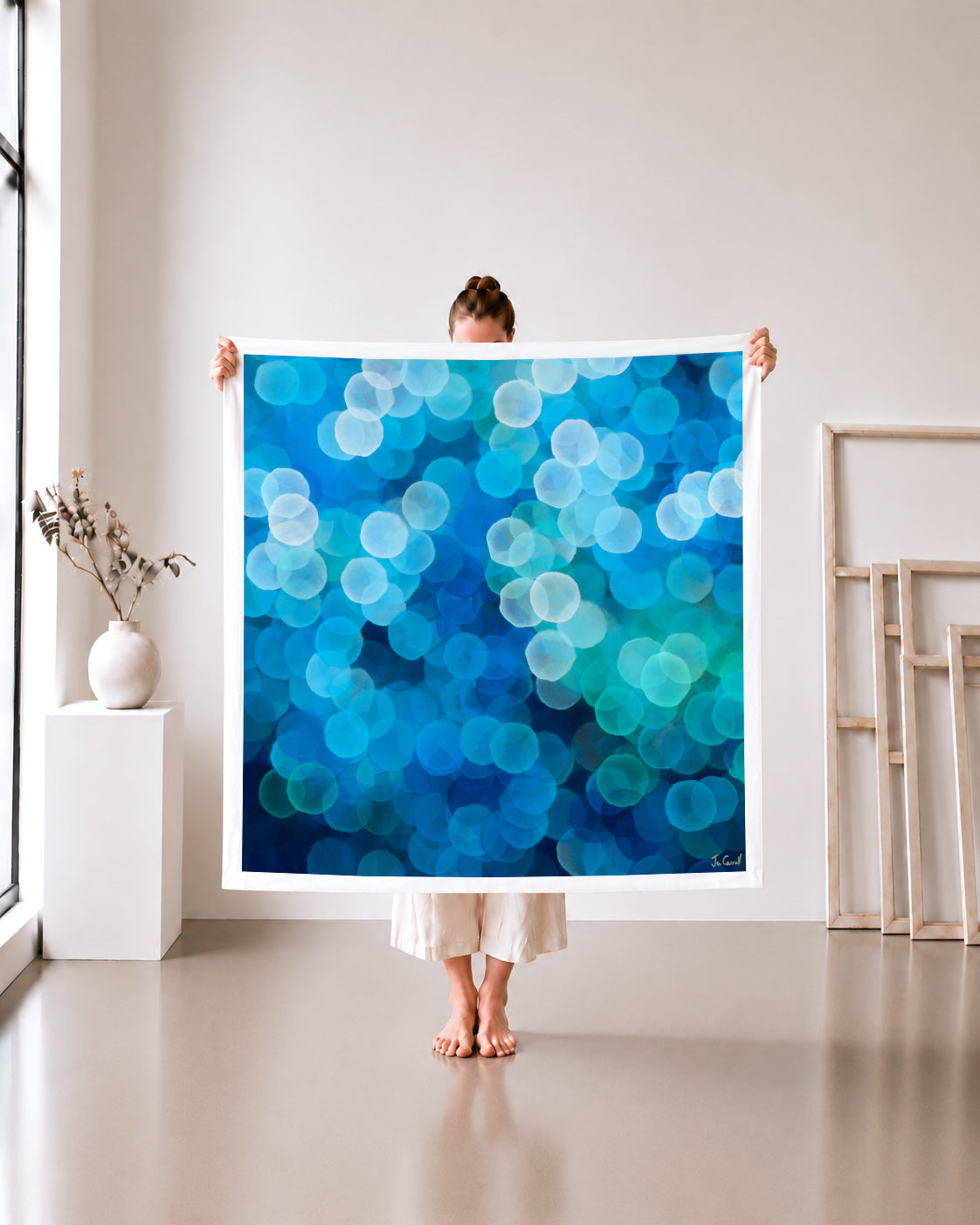 Orb Series 1 limited edition metallic canvas print, blue and teal orbs, 105x105cm unframed canvas held in a white studio