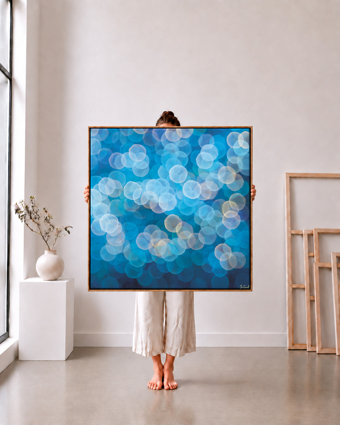 Orb Series 2A limited edition metallic canvas print, azure blue and peach orbs, 105x105cm oak frame held in a white studio