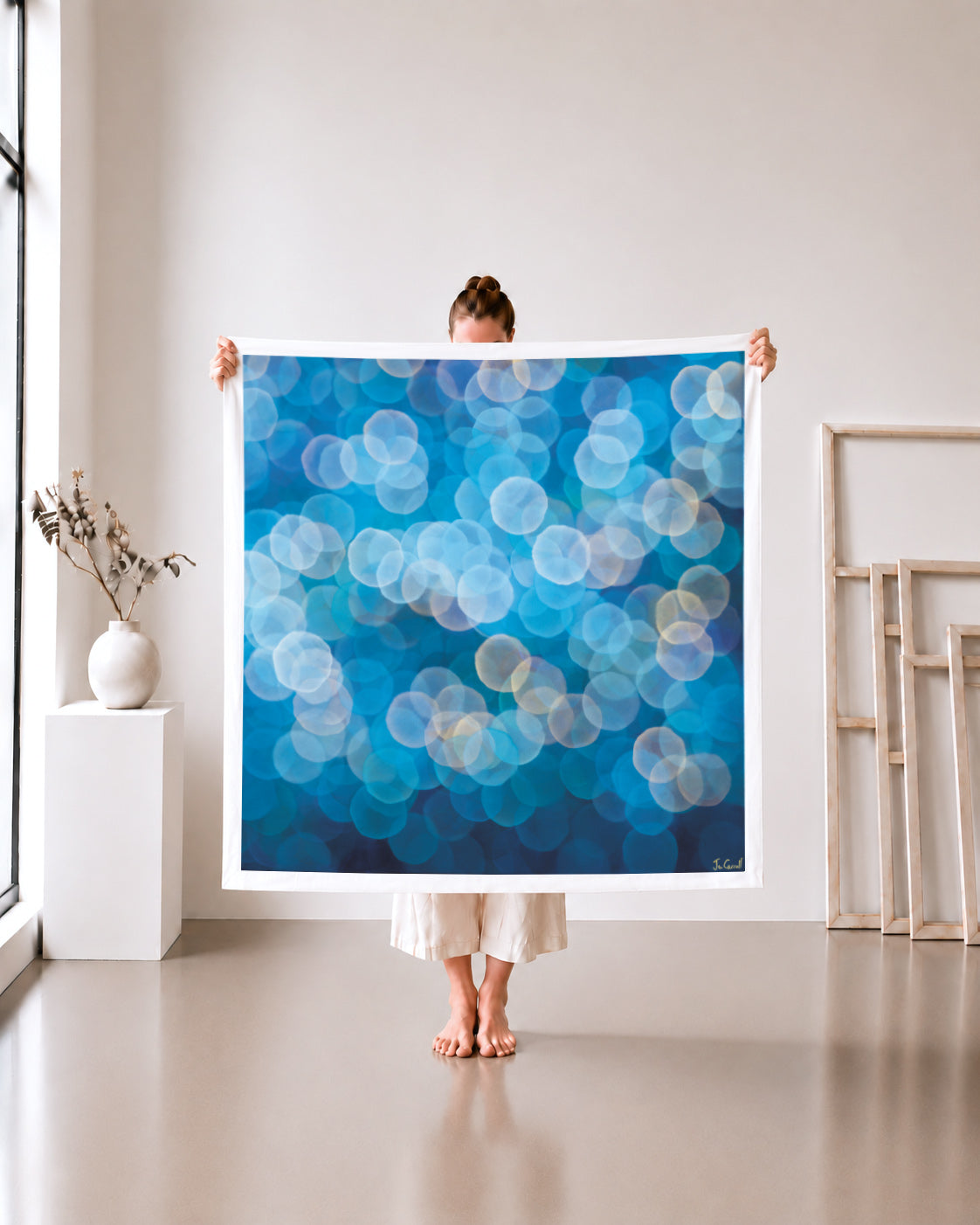 Orb Series 2A limited edition metallic canvas print, azure blue and peach orbs, 105x105cm unframed, held in a white studio